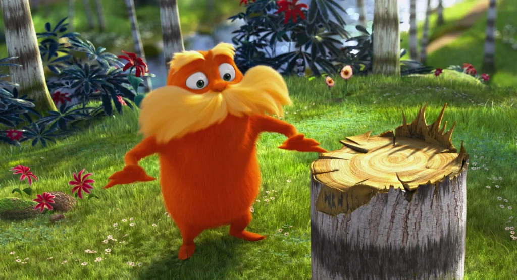 Karakter Lorax bertubuh oranye berdiri di samping tunggul kayu pohon Truffula sambil mengangkat tangan membela hak-hak alam.